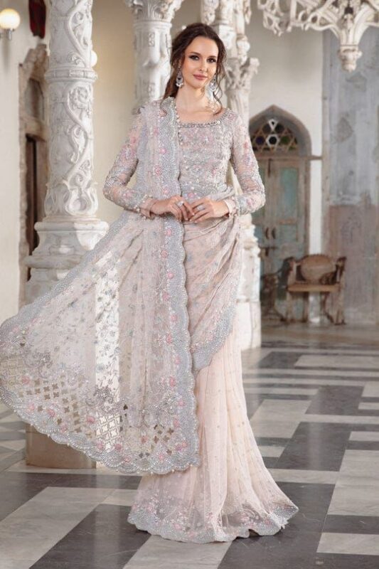 Maria B Peach Color Saree Collection 2025 available at sarastore.pk featuring heavily embroidered net, silk peticoat, and cut-work borders