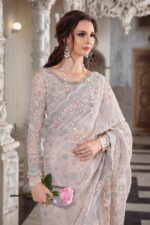 Maria B Peach Color Saree Collection 2025 available at sarastore.pk featuring heavily embroidered net, silk peticoat, and cut-work borders