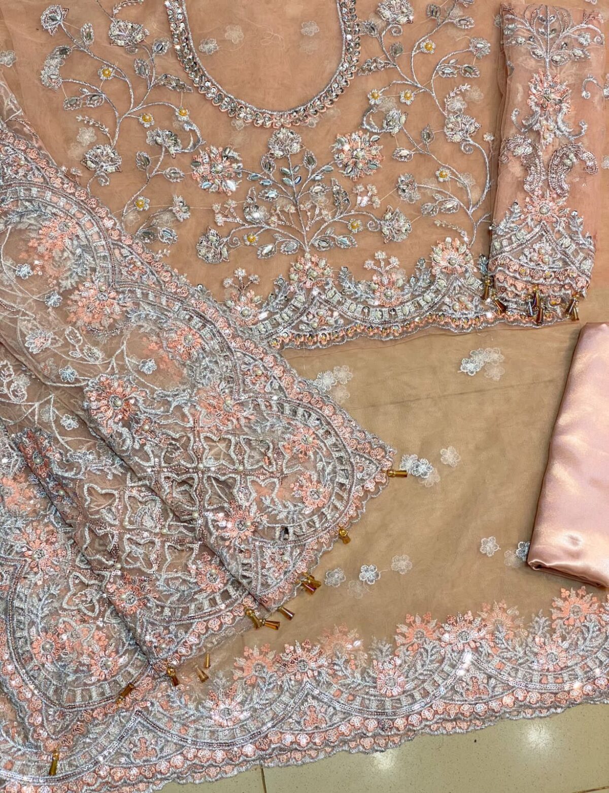 Maria B Peach Color Saree Collection 2025 available at sarastore.pk featuring heavily embroidered net, silk peticoat, and cut-work borders