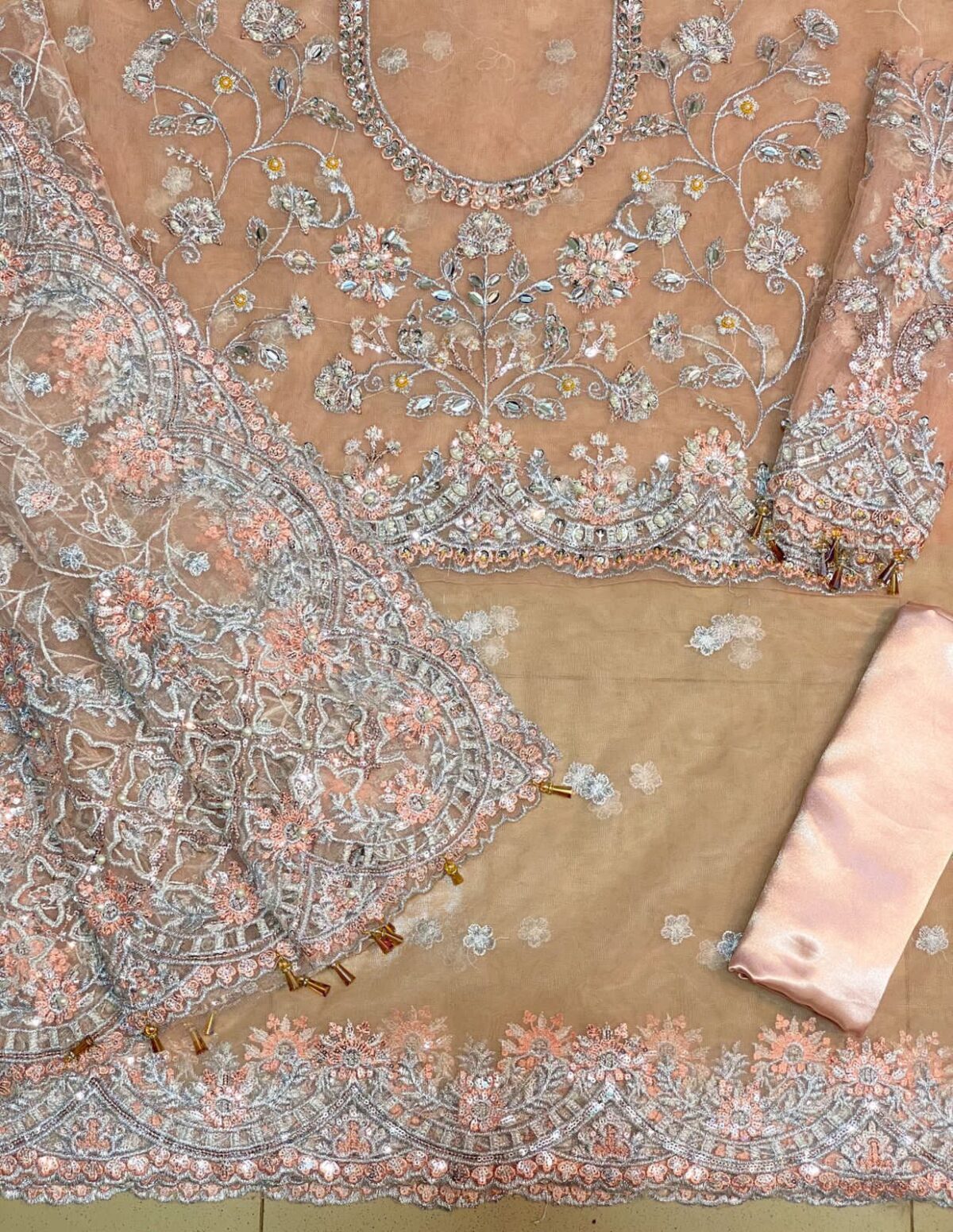 Maria B Peach Color Saree Collection 2025 available at sarastore.pk featuring heavily embroidered net, silk peticoat, and cut-work borders